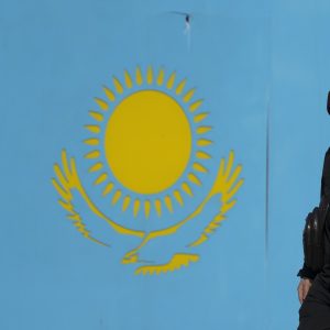 Soldier Standing in Front of Kazaks Flag