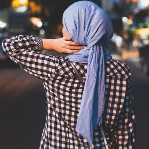 selective focus photograph of person wearing blue headscarf