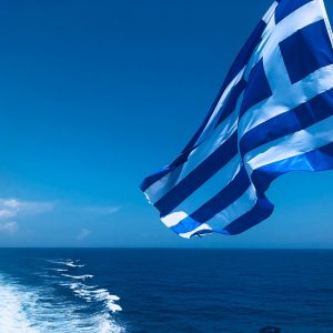 blue and white striped flag on the sea during daytime