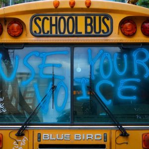 yellow school bus with green and yellow lights